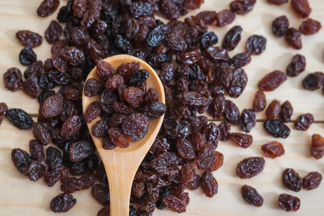 raisins on a wooden spoon raisins